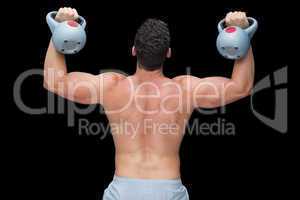 Strong bodybuilder lifting up kettlebells