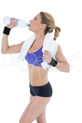 Strong blonde drinking from water bottle