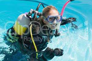 Smiling woman on scuba training in swimming pool