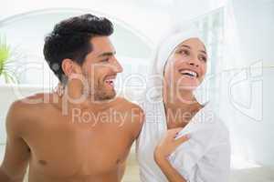 Attractive couple laughing in towels