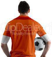 Football player in orange holding ball