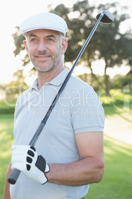 Smiling handsome golfer looking up