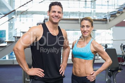 Bodybuilding man and woman smiling at camera