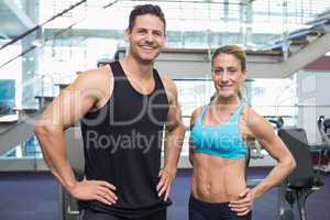 Bodybuilding man and woman smiling at camera