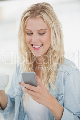 Cute blonde texting on phone