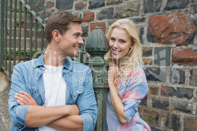 Hip young couple standing by steps