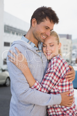 Hip young couple hugging in the road