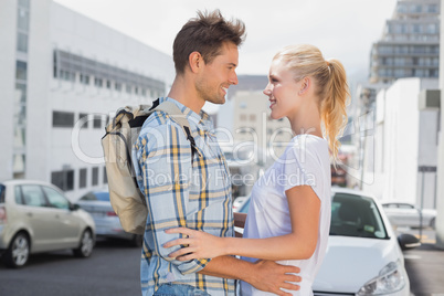 Hip young couple smiling at each other