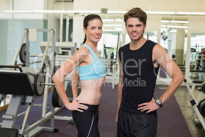 Fit man and woman smiling at camera together Fit man and woman smiling at camera together