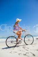 Pretty blonde on a bike ride at the beach