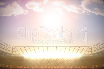 Large football stadium with spotlights under morning sky