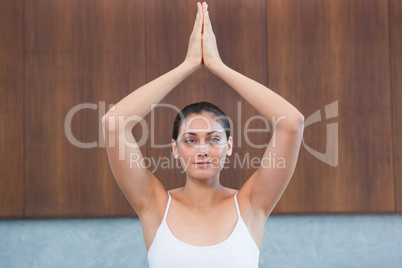 Peaceful woman in white sitting in lotus pose