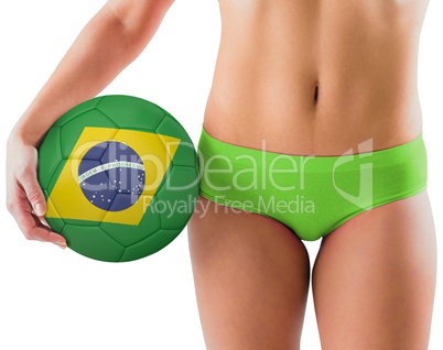 Fit girl in green bikini holding brazil football