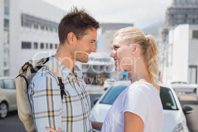 Hip young couple smiling at each other