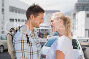 Hip young couple smiling at each other