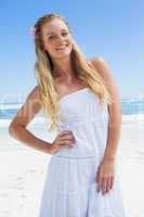 Pretty carefree blonde smiling at camera on the beach