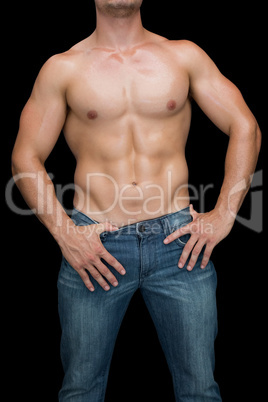 Muscular man posing in blue jeans
