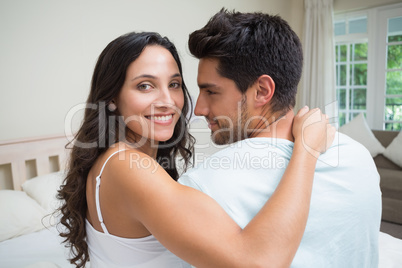 Attractive couple sitting on bed