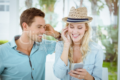 Hip young couple listening to music together