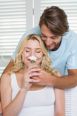 Pretty blonde smelling flower offered by boyfriend
