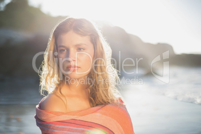 Beautiful blonde wrapped in scarf at the beach