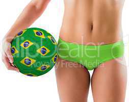 Fit girl in green bikini holding brazil football