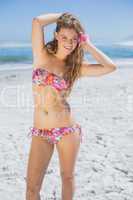 Beautiful smiling blonde with flower hair accessory on the beach