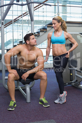 Bodybuilding man and woman smiling at each other