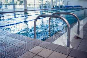 Swimming pool with hand rails