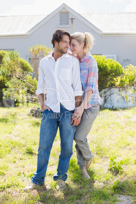 Cute couple standing together in their garden