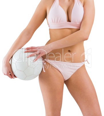 Pretty girl in bikini holding football