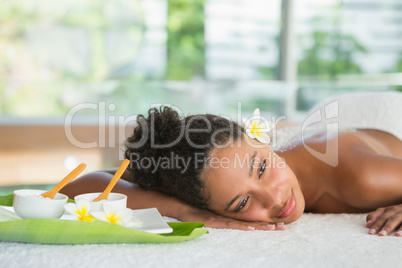 Gorgeous woman lying on massage table with salt treatment on bac