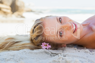 Pretty carefree blonde lying on the beach