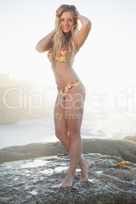 Gorgeous blonde in floral bikini posing at the beach