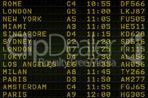 Black airport departures board with yellow text