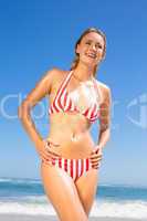 Smiling fit woman in bikini on the beach