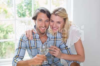 Cute smiling couple enjoying white wine together