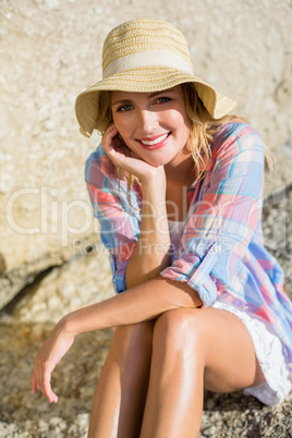 Pretty blonde smiling at camera at the beach