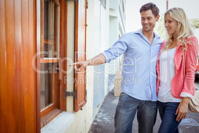 Stylish young couple window shopping