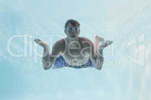 Man shrugging shoulders underwater in swimming pool