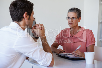 Casual businesswoman talking with colleague