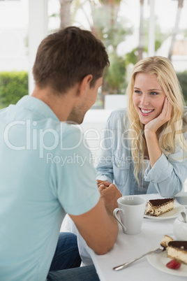 Hip young couple having coffee together