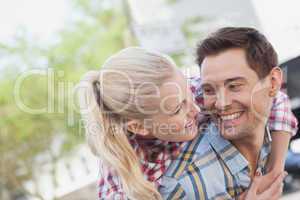 Man giving his pretty girlfriend a piggy back