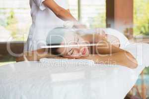 Brunette enjoying a peaceful massage with eyes closed