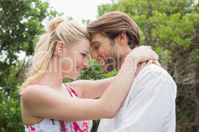 Cute couple standing outside hugging