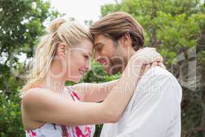 Cute couple standing outside hugging