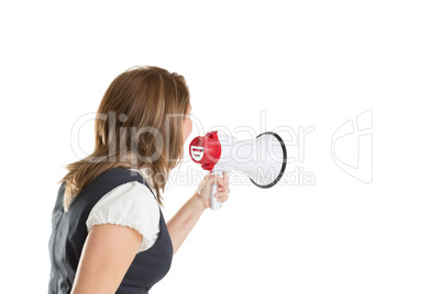 Young businesswoman shouting into bullhorn