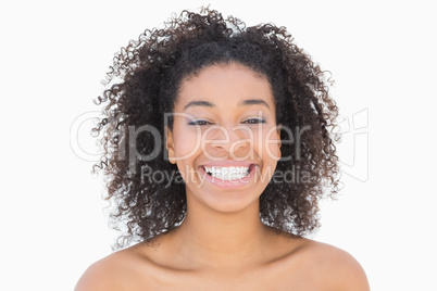 Pretty girl with afro hairstyle smiling at camera