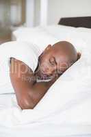 Peaceful man sleeping in bed