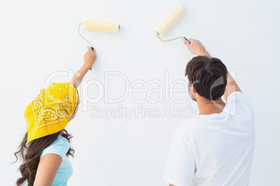 Happy young couple painting together